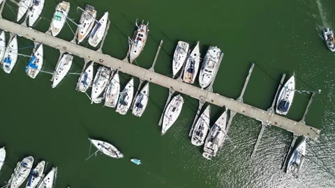 Aerial view of calm harbor with numerous docked boats Stock Footage 346829587