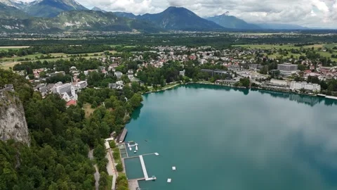 Aerial view of a calm lake surrounded by dramatic mountain landscape Stock Footage 322045351