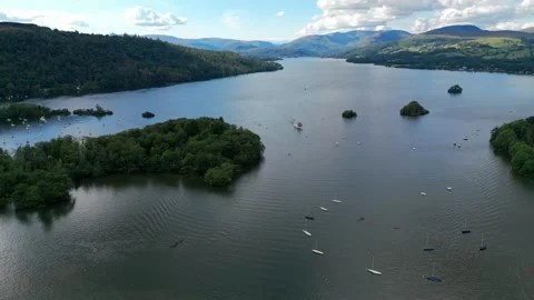 Aerial view of calm lake surrounded by forested hills Stock Footage 345522213