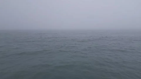 Aerial View of Calm Ocean Waves Disappearing into Thick Fog Video stock 332711574