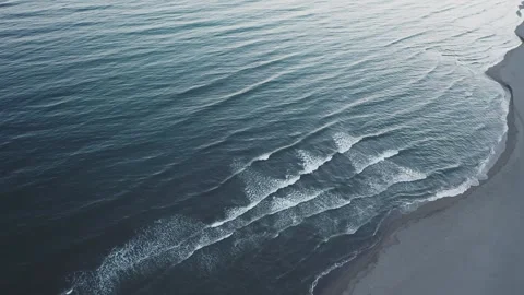 Aerial view of calm ocean waves crashing on empty sandy beach during peacef.. Stock Footage 337546682