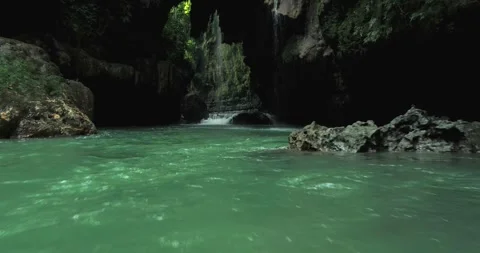 Aerial View of Calm River Flow Through Tropical Canyon with Clear Water Stock-Footage 332489412