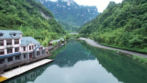 Aerial view of a calm river flowing through a lush green mountain valley Stock Footage 342233646