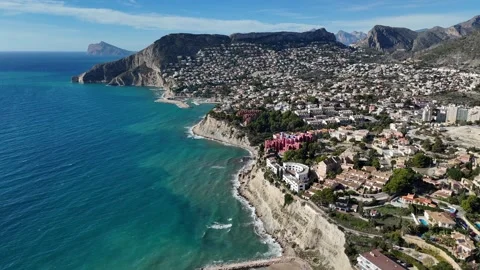 Aerial view of Calpe coastline with cliffs and houses Spain Stock Footage 332571204