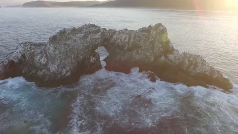 Aerial view. camera flies around the island in an ocean on which sit the birds Stock Footage 72745271