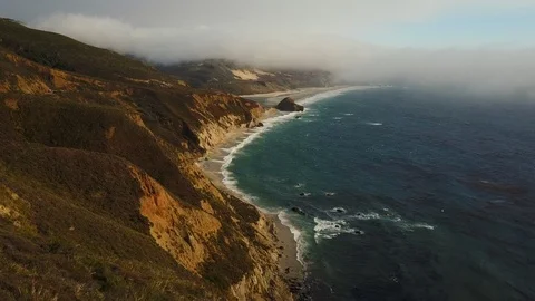 Aerial view: Camera floats above the rocky coast of Big Sur in Monterey County Stock Footage 93760147