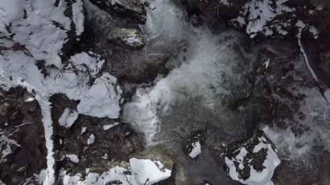 Aerial view. Camera looks down on mountain waterfall while the drone goes up Stock Footage 153958934