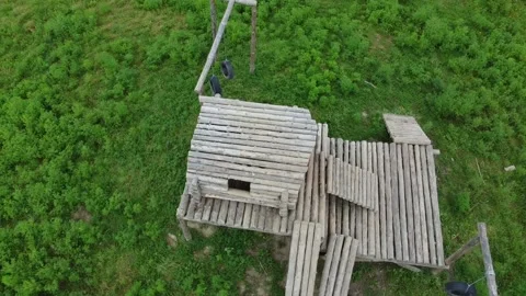 Aerial view, the camera makes a circle around a wooden building Stock Footage 209166868