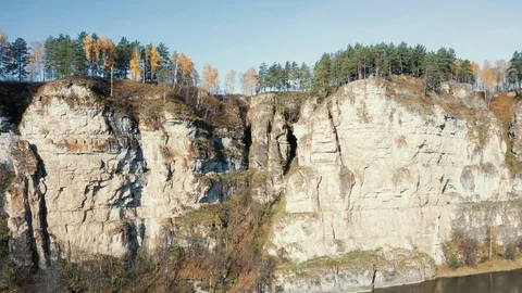 Aerial view; camera making panorama of landscape with cliffs forest Stock Footage 117997218