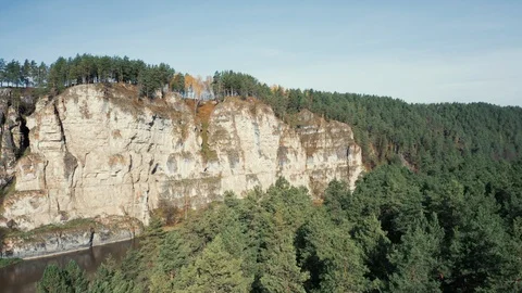 Aerial view; camera making panorama of landscape with cliffs forest Stock Footage 118000807