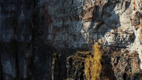 Aerial view; camera moving along rocky cliff of river Stock Footage 117992088