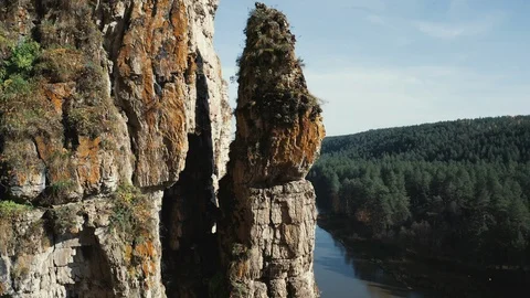 Aerial view; camera moving around steep cliff Stock Footage 118002879