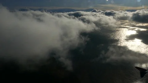 Aerial view of camera moving inside clouds from above in sky sea in background Stock Footage 92641622