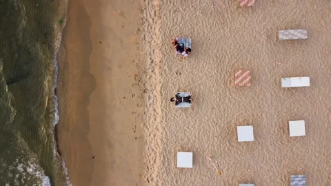 Aerial View The Camera is Pointing Down the Beach and White Sand, A Young Man Is Stock Footage 228325334