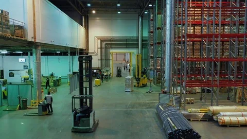 Aerial view camera rushes from right to left past the huge shelves and rows Stock Footage 113090159