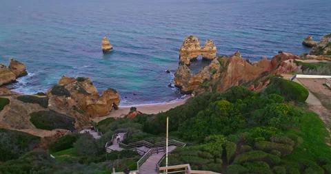Aerial view of Camilo beach in Lagos, Algarve, Portugal. Long wooden staircase Stock Footage 311114571