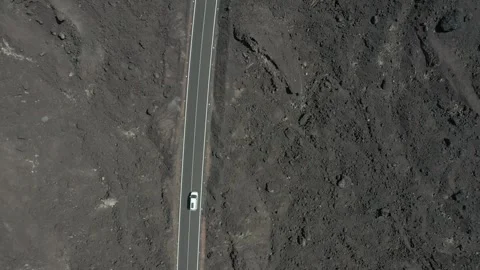 Aerial view of a camper van driving on a road in a volcanic landscape Stock Footage 159440133