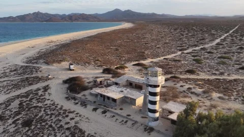 Aerial view of a camper van parked by the lighthouse at Punta Arena, Baja Stock Footage 346486439