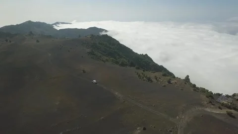 Aerial view of a camper van on top of a mountain with a sea of clouds below Stock Footage 159440149