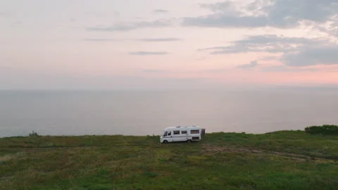 Aerial view Camper Vans sunset calm sea turn. Stock Footage 232132079