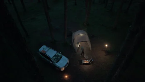Aerial view, camping alone in the pine forest with SUV car in evening Video stock 289343681