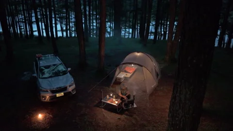 Aerial view, camping alone in the pine forest with SUV car in evening Stock-Footage 289344768