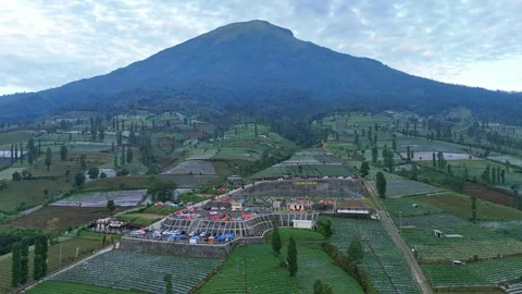 Aerial view of a camping area filled with tents on a mountainside. Stock Footage 311516403