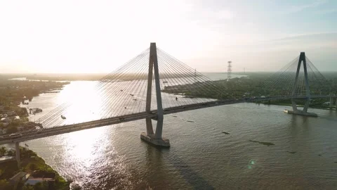 Aerial view of can tho bridge crossing mekong river with sunset sun flare a.. Video stock 335017423