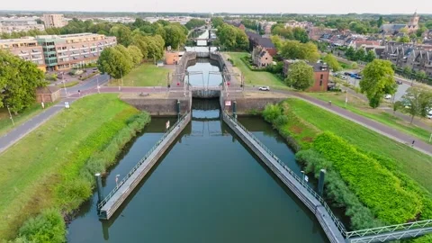 Aerial view of canal lock and bridge in Dutch town on sunny summer day Video stock 342176404