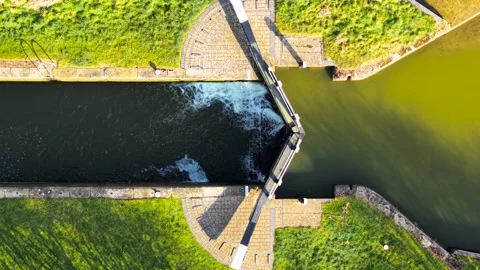 Aerial view canal lock balancing water levels. Overhead shot sluice gate Stock Footage 312603203