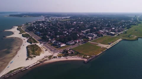 Aerial view of Cape Charles beach, breakwater jetty, and coastal town in Virgini Stock Footage 344764038