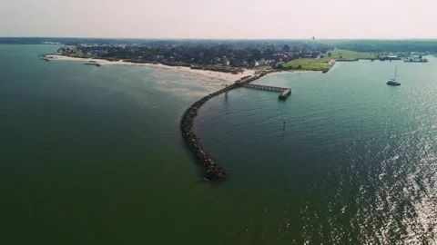 Aerial view of Cape Charles beach, breakwater jetty, and coastal town in Virgini Stock Footage 344764104
