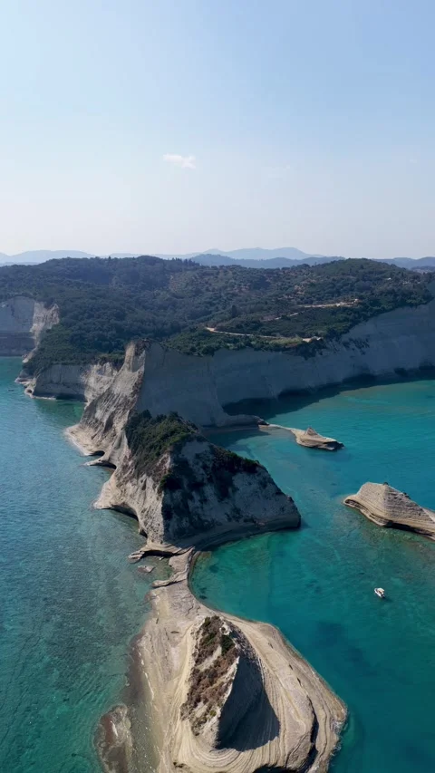 Aerial view of Cape Drastis cliffs and turquoise sea in Corfu, Greece. Vertical Stockbeeldmateriaal 345001386