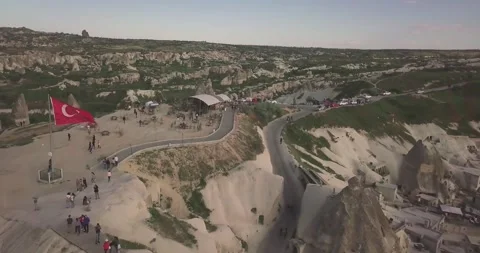 Aerial View of Cappadocia Viewpoint with Turkish Flag Waving over Goreme Valley Stockbeeldmateriaal 337699641