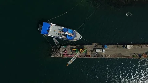 Aerial view captures a boat secured at a pier. Ideal for business concept Vídeos de archivo 335300197