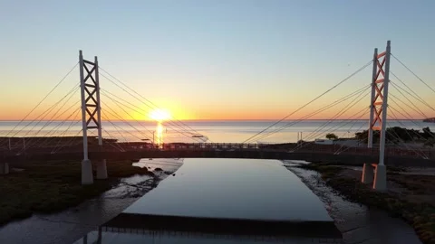 Aerial view captures bridge during sunrise with vivid colors Stock Footage 345222432