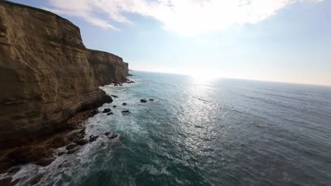 Aerial view captures cliff edge meeting ocean Stock Footage 340224706
