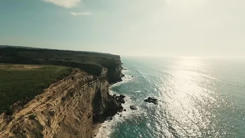 Aerial view captures cliff edge meeting ocean Stock Footage 340225922