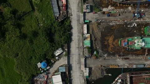 Aerial view captures coastal construction site by water. Ideal for shipping Vídeos de archivo 335302670
