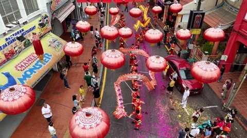 Aerial view captures dragon dance performance during temple parade Stock Footage 332097090