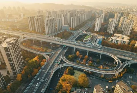 Aerial view captures elevated highway interchange weaving through a dense 스톡 사진