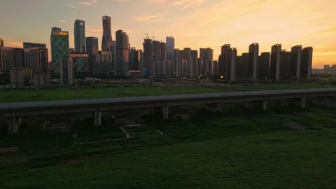 Aerial view captures elevated railways against Hangzhou modern skyline with lush Stockbeeldmateriaal 341642630