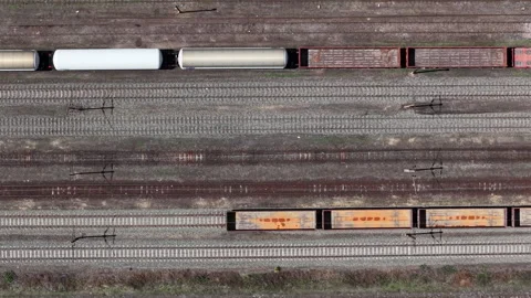 An aerial view captures a freight train transporting cargo across the railway Stock Footage 337470540