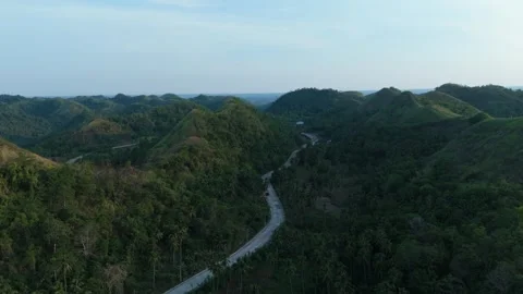Aerial view captures green mountains and winding road. Stock Footage 337256844