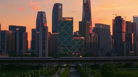 Aerial view captures high speed bullet train moves across the city landscape of Stock Footage 341836993