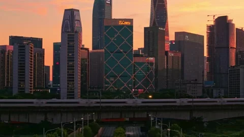 Aerial view captures high speed bullet train moves across the city landscape of Stock-Footage 344880167