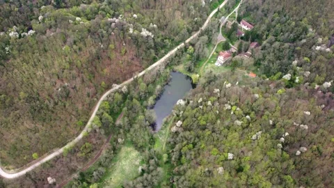 An aerial view captures a hilly area blanketed in woods Stock-Footage 260089200