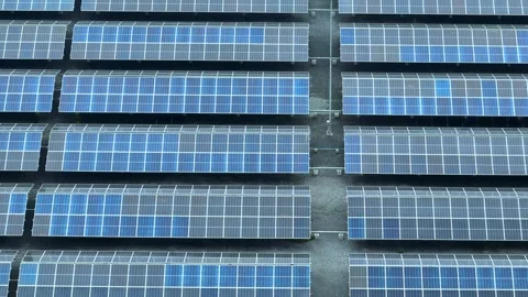 An aerial view captures a large array of solar panels. Stock Footage 306734806