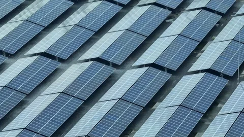 An aerial view captures a large array of solar panels. Stock Footage 306735667