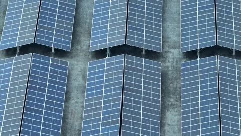 An aerial view captures a large array of solar panels. Stock Footage 306735676